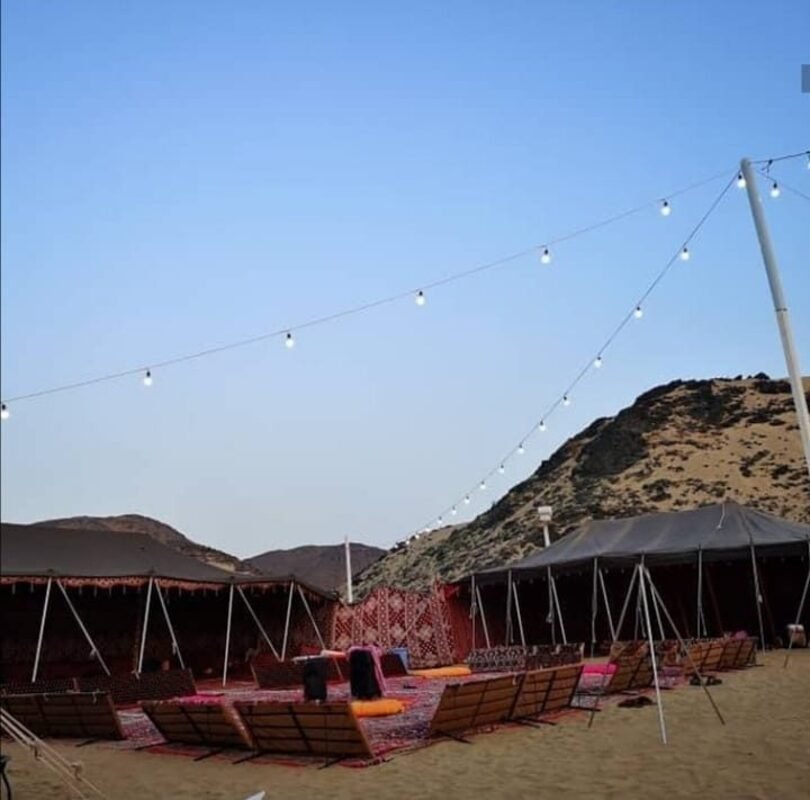 Bedouin tents with string lights during the day