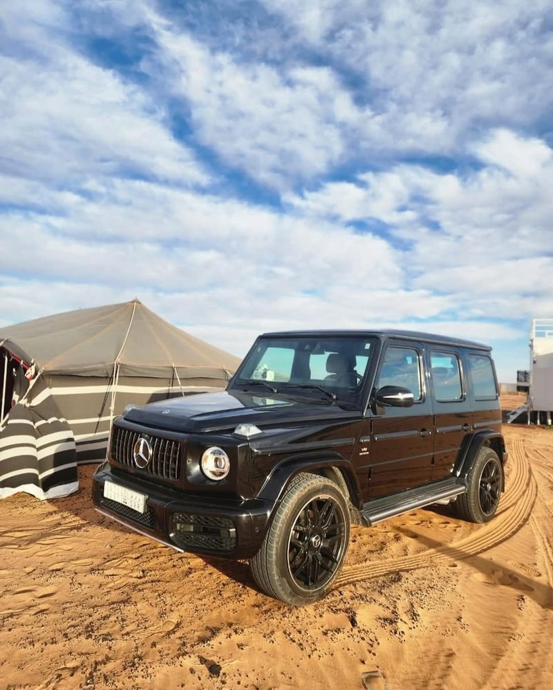 Mercedes G-Wagon parked at the desert camp