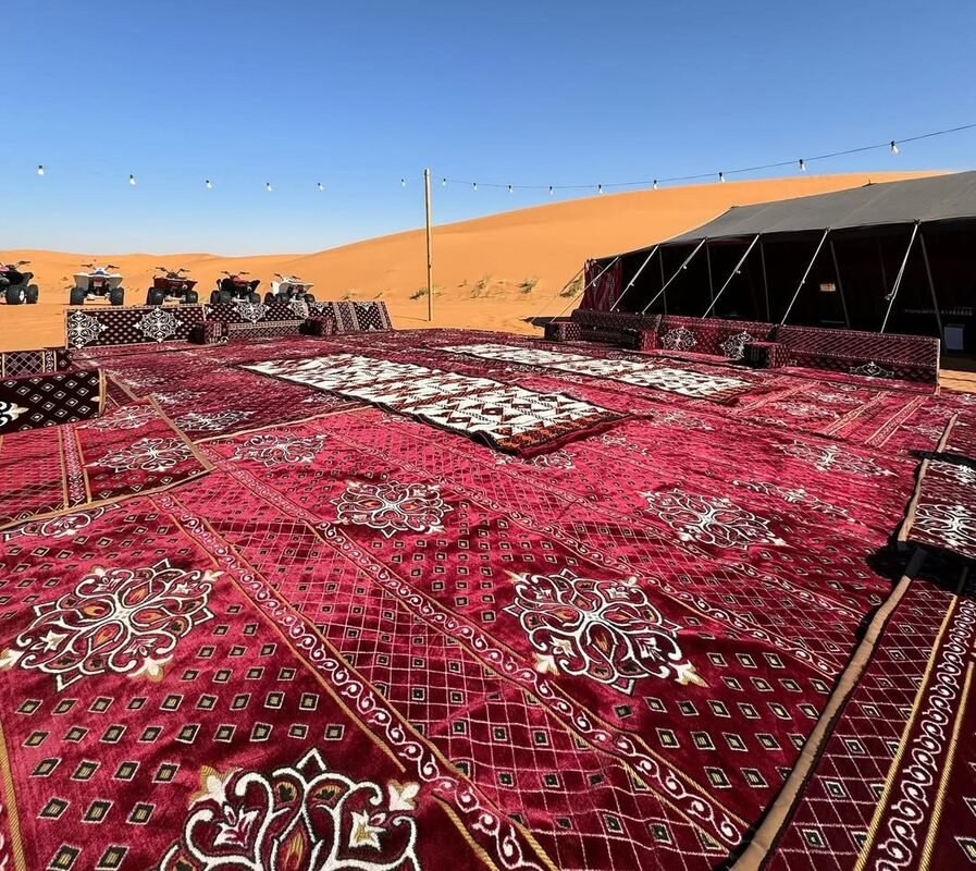 Traditional red carpets in front of a Bedouin tent